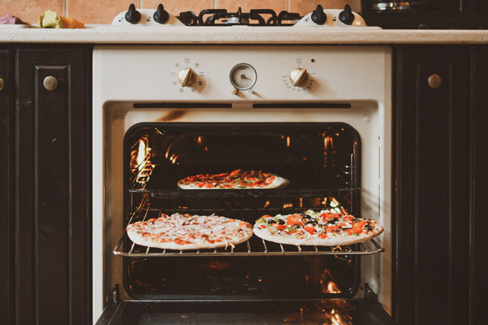 Frozen pizzas in oven