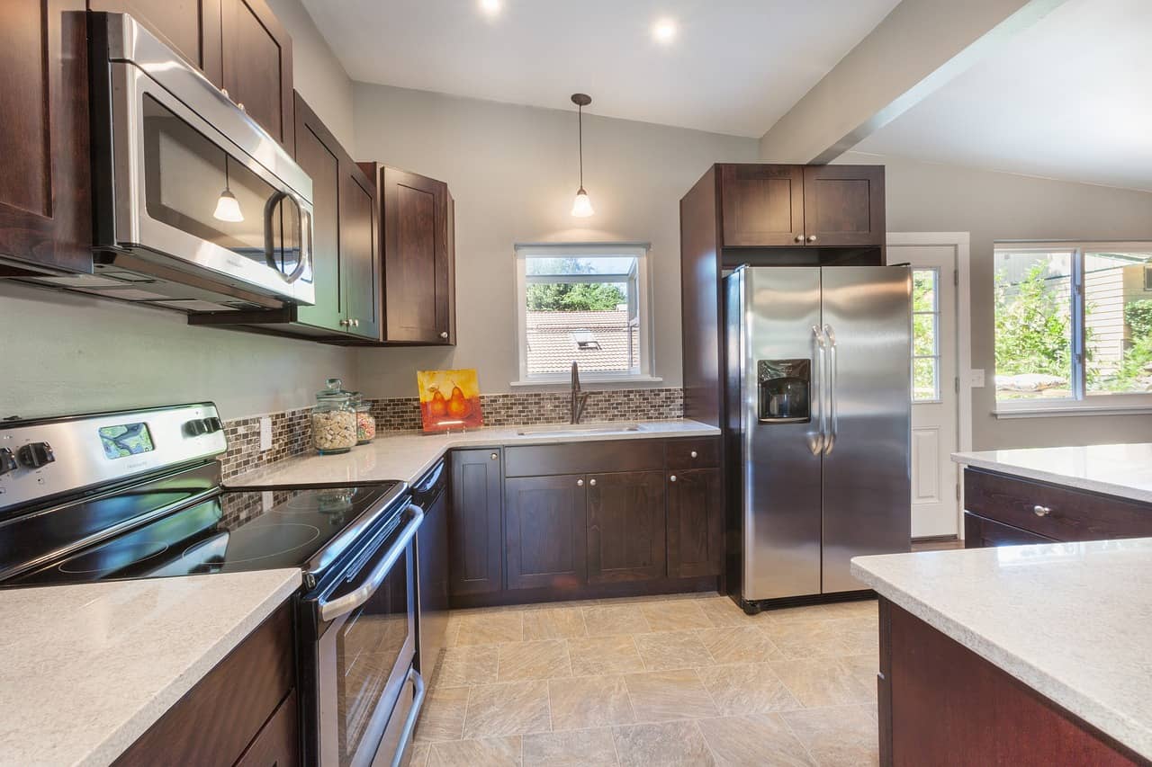 kitchen with dark cabinets and appliances