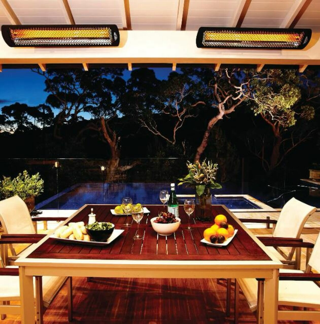 Modern outdoor patio heaters ceiling-mounted in a backyard patio gazebo with dinner setting