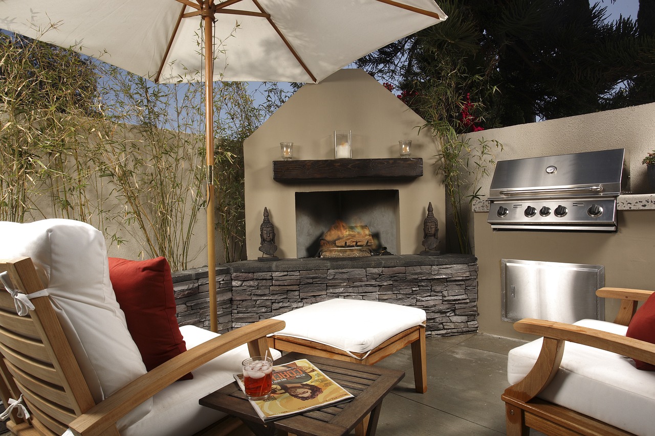 outdoor fireplace near two white chairs