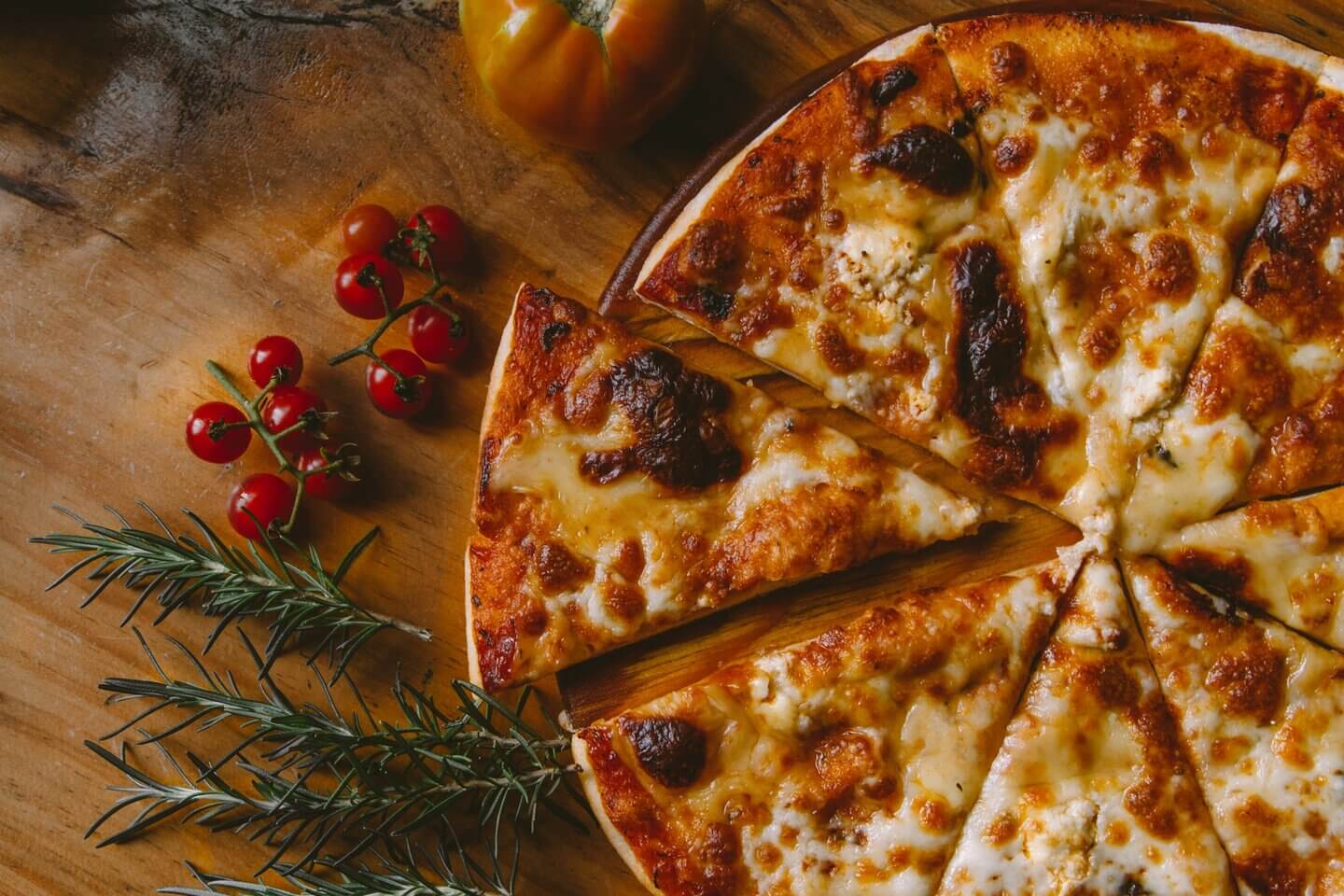 Photo of a pizza on a wooden surface