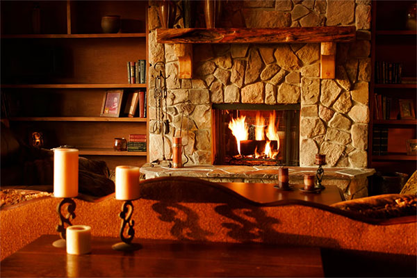 Wood fireplace with a stone hearth and wood mantel and shelved walls